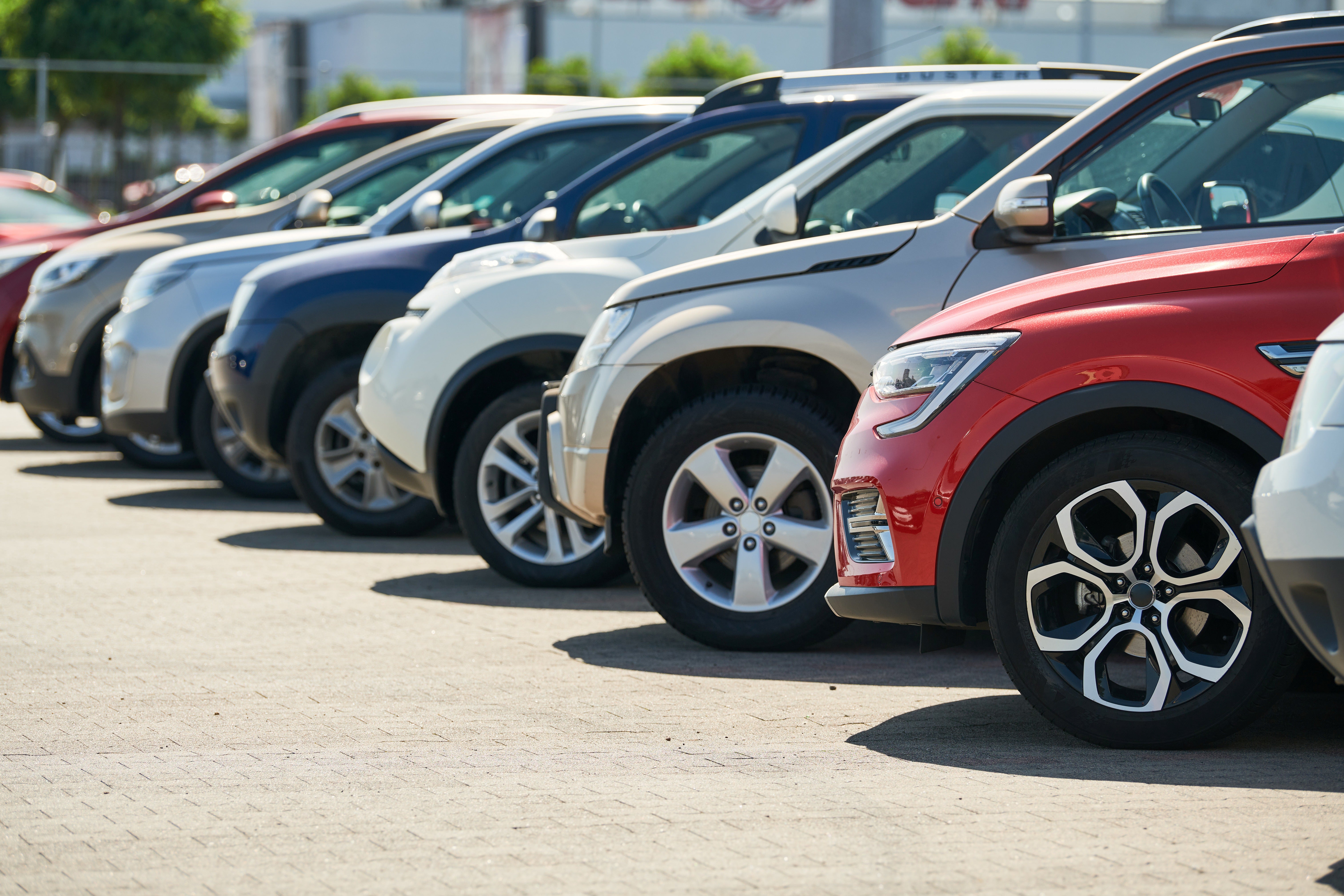 A row of used cars for sale at a car dealership